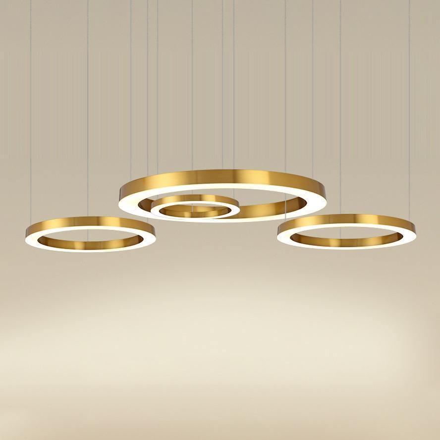 Close view of a gold ring cluster glowing against a soft beige background, with the lit inner faces of this Clérachic ring pendant visible.