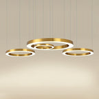 Close view of a gold ring cluster glowing against a soft beige background, with the lit inner faces of this Clérachic ring pendant visible.