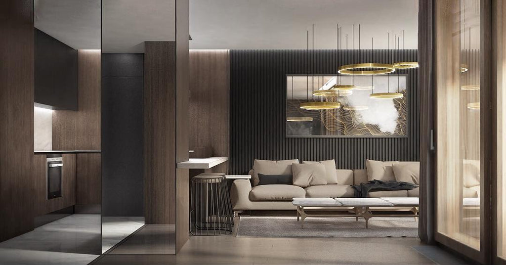 Gold rings hang over an open dark-timber kitchen and lounge with a cream sofa and a large painting, seen in a wide room view with this Clérachic pendant.