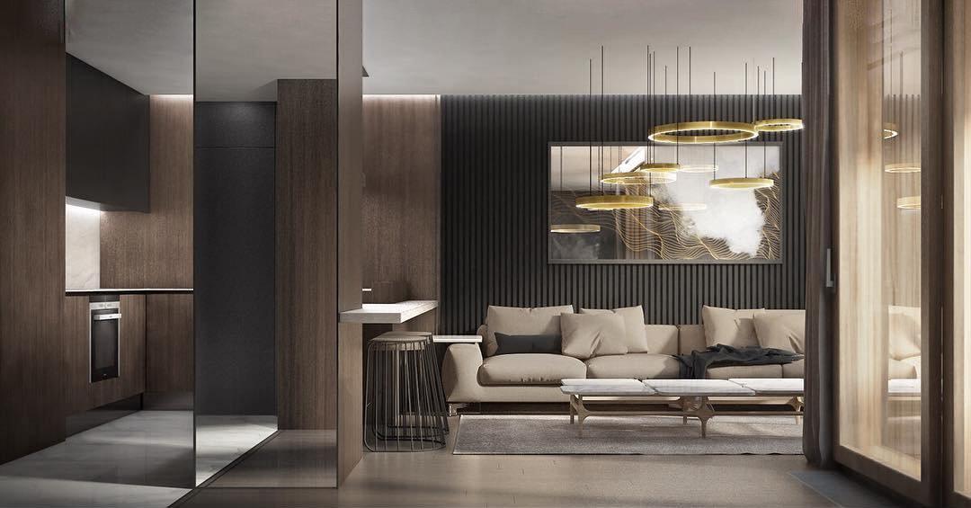 Gold rings hang over an open dark-timber kitchen and lounge with a cream sofa and a large painting, seen in a wide room view with this Clérachic pendant.
