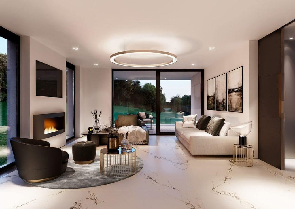 One lit ring pendant hangs in the centre of a long white living room with a marble floor and garden doors, in a Clérachic ring pendant style.