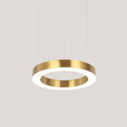 A single brushed gold ring pendant lit from inside, hanging on thin cables against a pale grey backdrop, a Clérachic ring light.