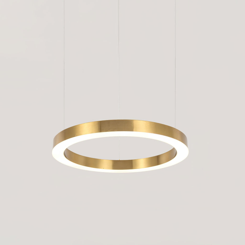 A single brushed gold ring with a white lit underside hangs on thin cables against pale grey, a mid-size Clérachic ring pendant.