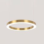 A wide gold ring pendant with a lit white underside hangs on fine cables against a plain grey backdrop, a Clérachic ring light.
