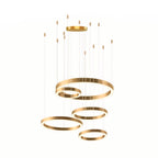 A tall arrangement of five gold rings hangs from a ceiling plate at staggered heights on a white backdrop, shown as a Clérachic pendant.