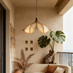 Clérachic pendant light in a plastered room with a large monstera and dried ferns, beside a built-in cream bench.