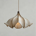 Front view of this Clérachic pendant light on a pale grey backdrop, unlit, with its petals folding in towards the lamp.