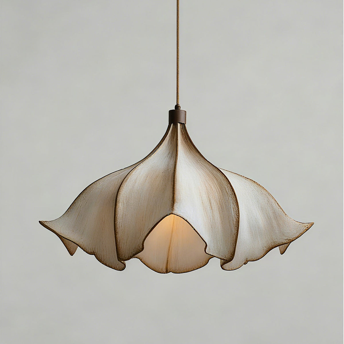 Front view of this Clérachic pendant light on a pale grey backdrop, unlit, with its petals folding in towards the lamp.