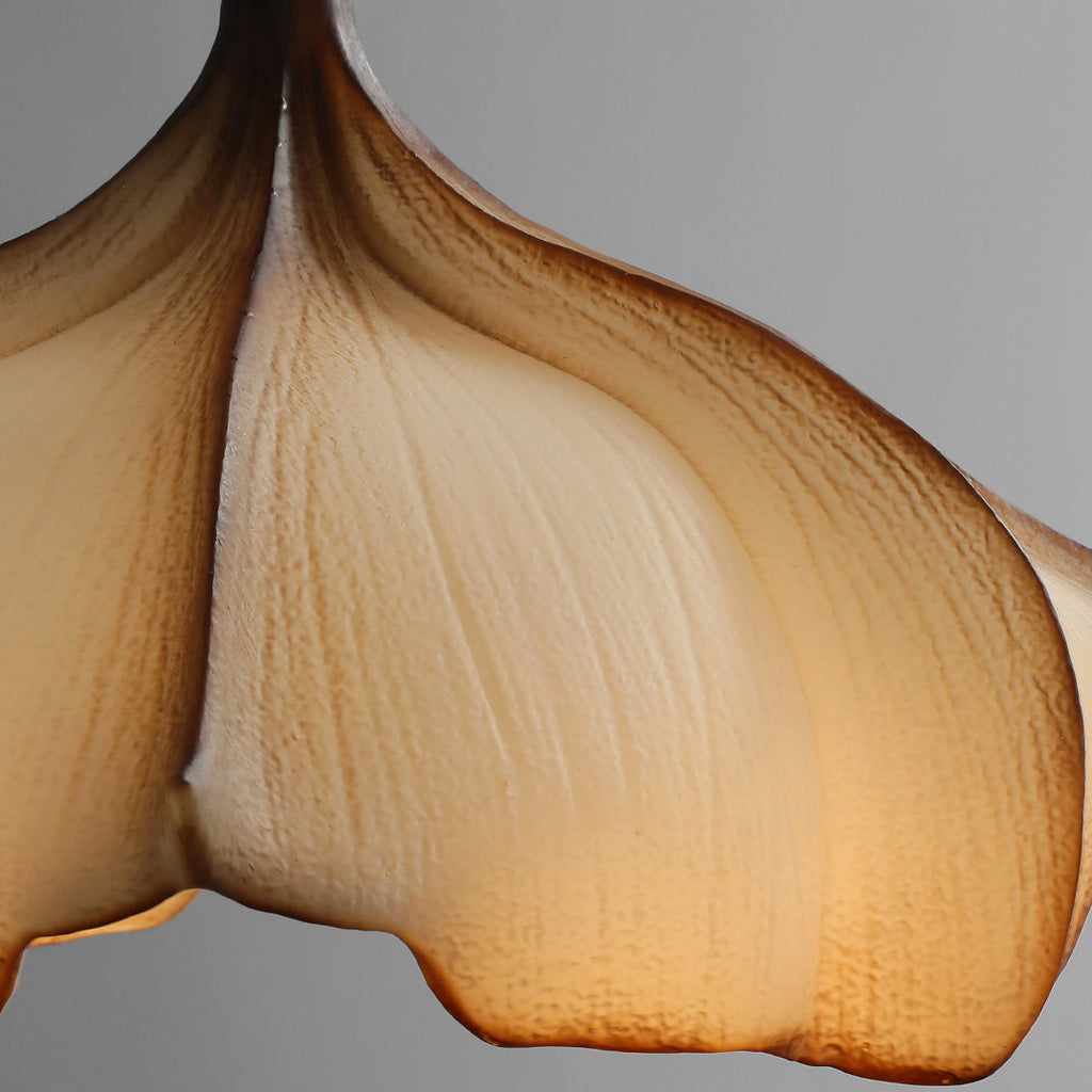 Close view of one petal of this Clérachic pendant, with fine veining in the cream and brown fabric lit from inside.