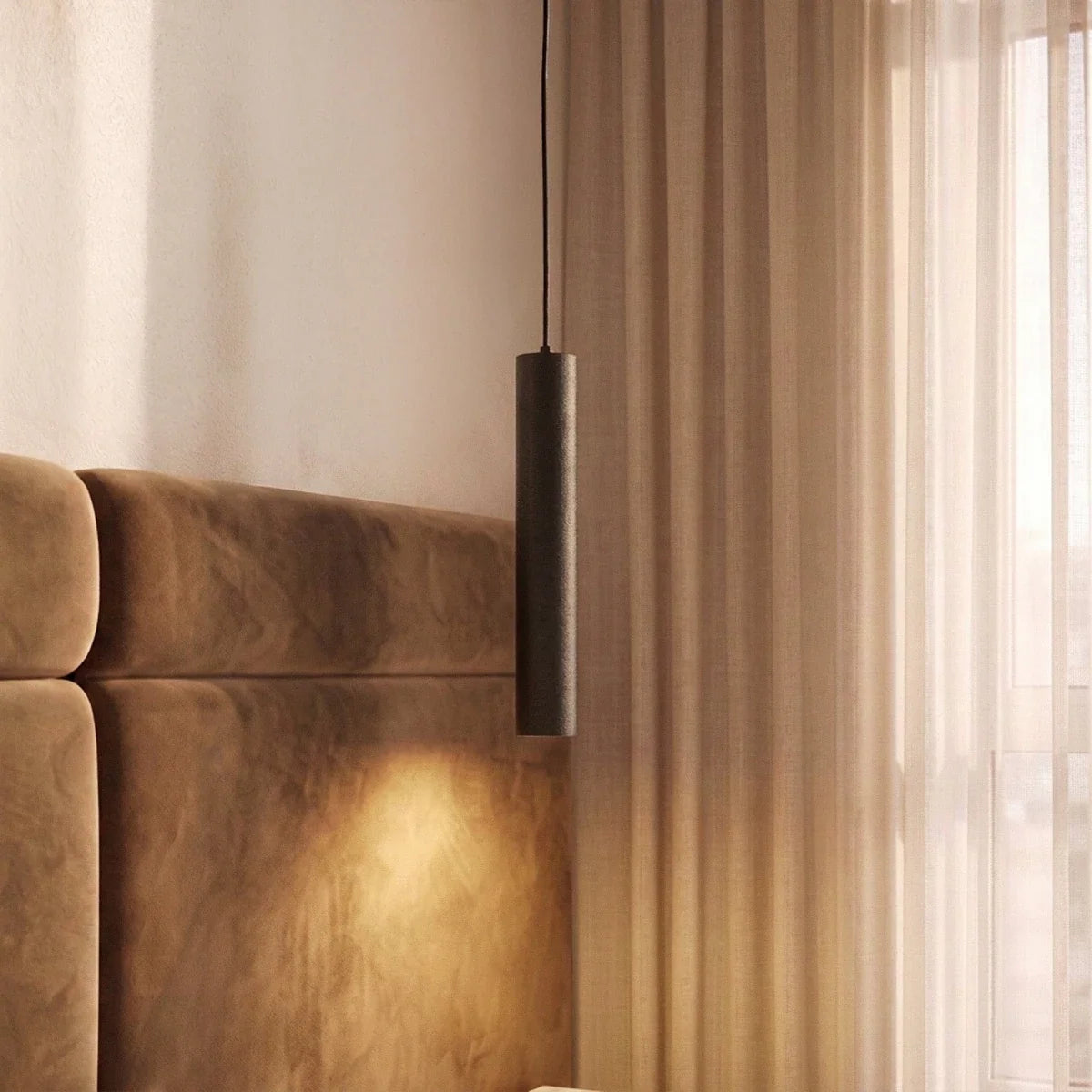 Clérachic slim black textured cylinder pendant light on a black cord beside sheer curtains and a velvet headboard.