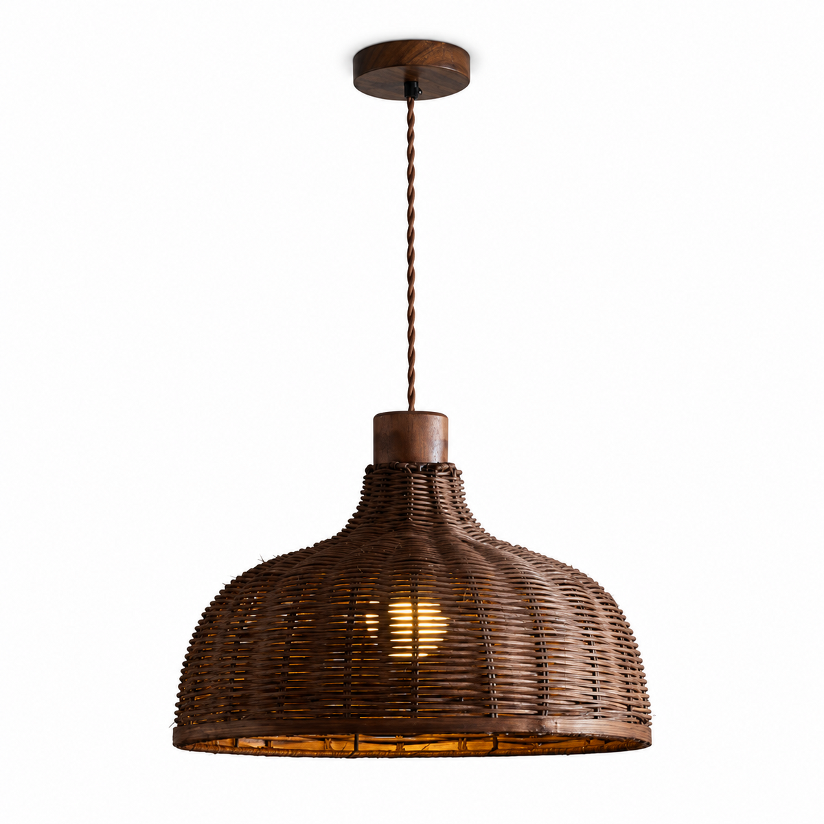 This Clérachic pendant's wide, rounded rattan shade hangs alone against a plain white backdrop.