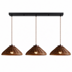 This Clérachic pendant's three-light bar carries wider, flared rattan shades, photographed against a plain backdrop.