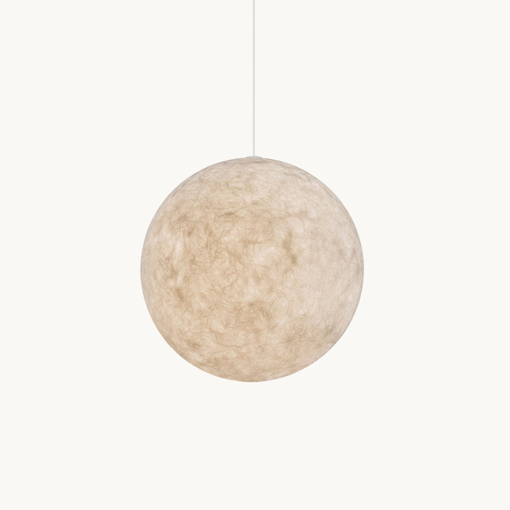 A Clérachic textured white sphere pendant hangs on a thin cord against a plain off-white backdrop, its fibrous shell unlit.