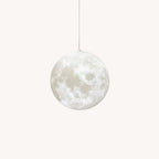 A pale grey moon-print globe pendant from Clérachic hangs from a fine cord, its cratered surface visible against white.
