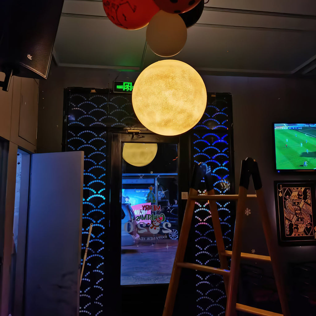 A warm yellow Clérachic sphere glows in a dark bar doorway, with a ladder and a screen showing a football match nearby.
