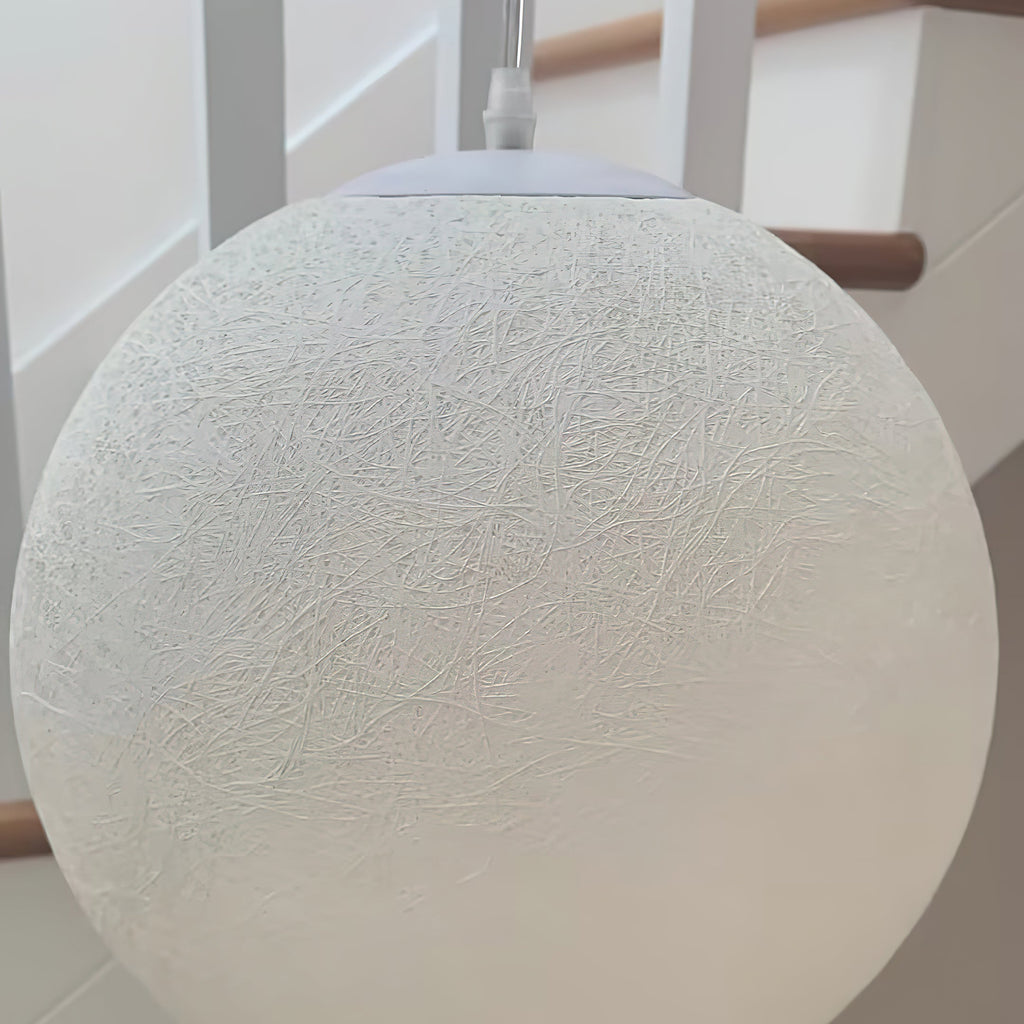 Close view of the fine, web-like fibre texture on a large white Clérachic sphere, with the white canopy and cord at the top.