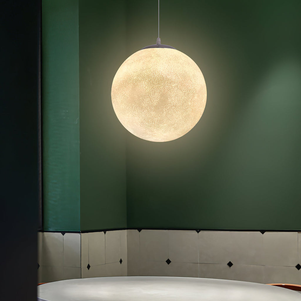 A single lit Clérachic sphere hangs against a deep green wall with a pale tiled lower section.