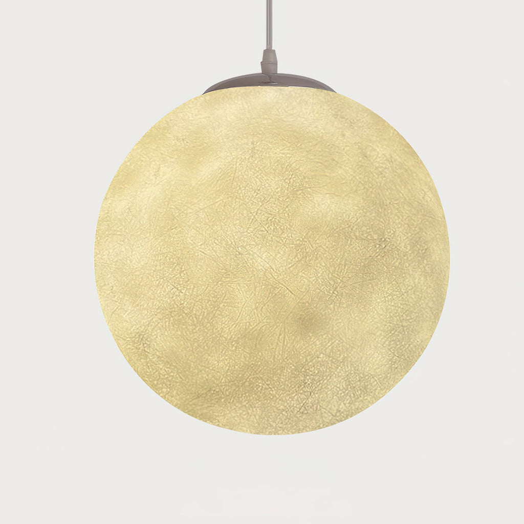 Lit Clérachic sphere glowing warm yellow, its crater-like surface visible, hung from a grey canopy against a pale backdrop.