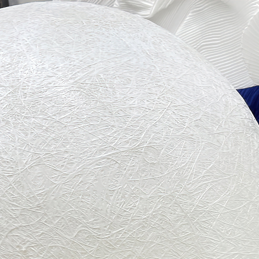 Close-up of the web-like white fibre texture across the curve of this Clérachic sphere, with a blue and white fabric edge beyond.