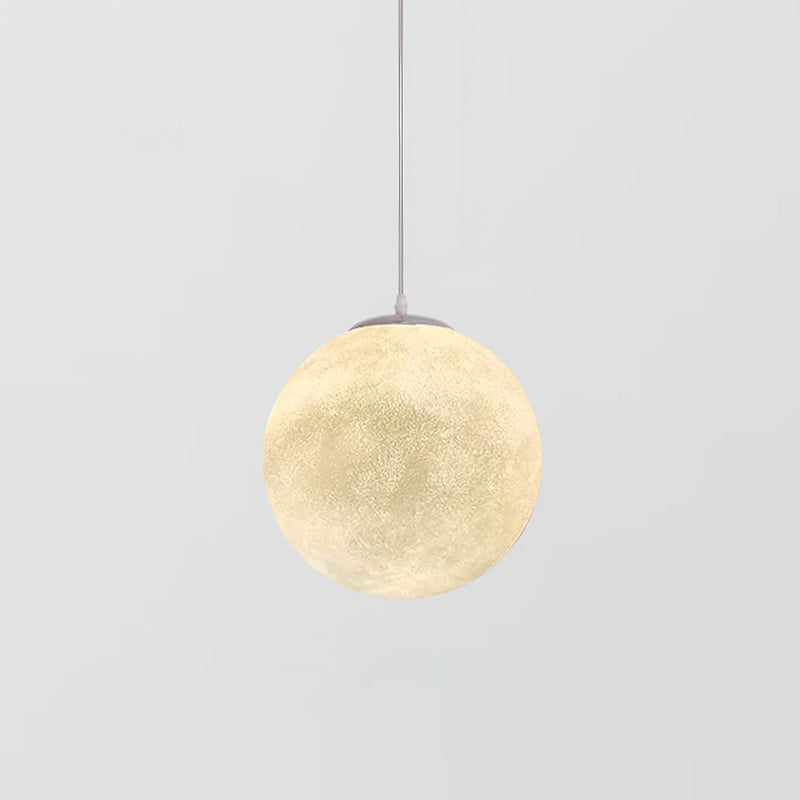 A small Clérachic sphere pendant glows warm cream on a slim white cord, centred against a light grey backdrop.