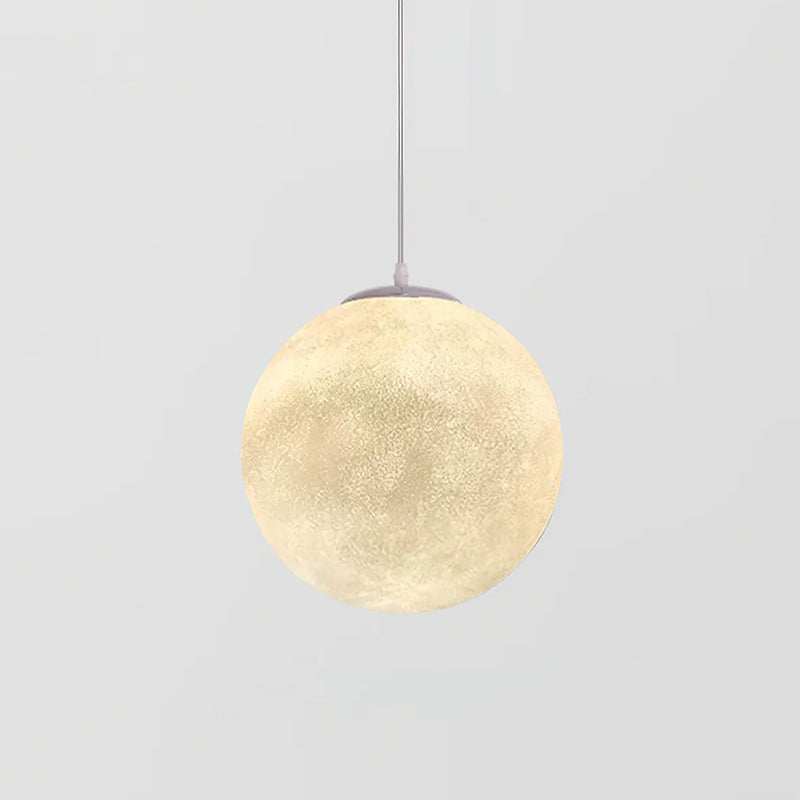Mid-size Clérachic sphere pendant glowing warm cream, with a grey canopy and thin cord, against a plain light grey backdrop.