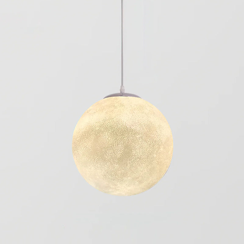 A larger Clérachic sphere pendant, lit, showing the crater-like texture and a grey canopy on a pale grey background.