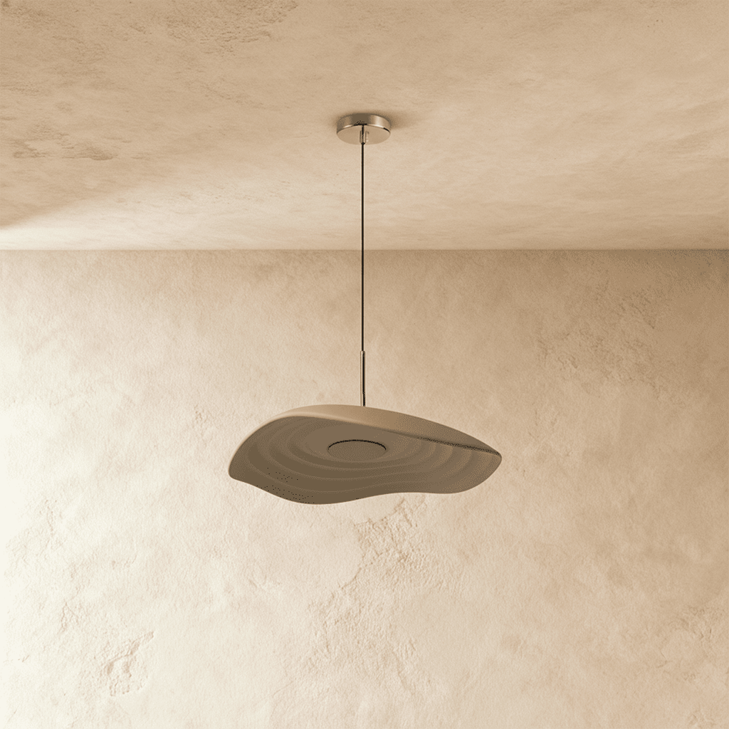 Clérachic wavy, layered resin pendant in taupe, unlit, hanging from a polished metal canopy over a plaster wall