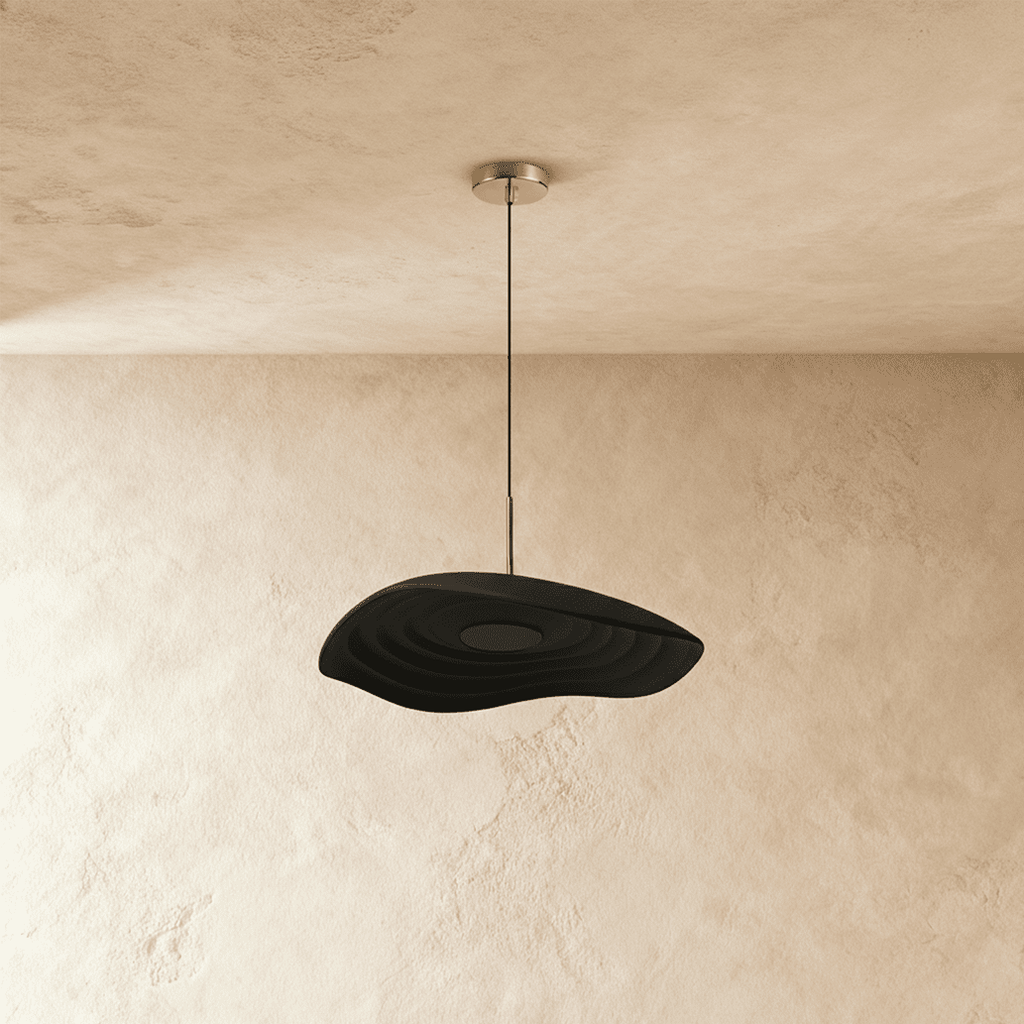 Clérachic wavy black resin pendant with concentric ripples, hanging from a polished canopy against plaster