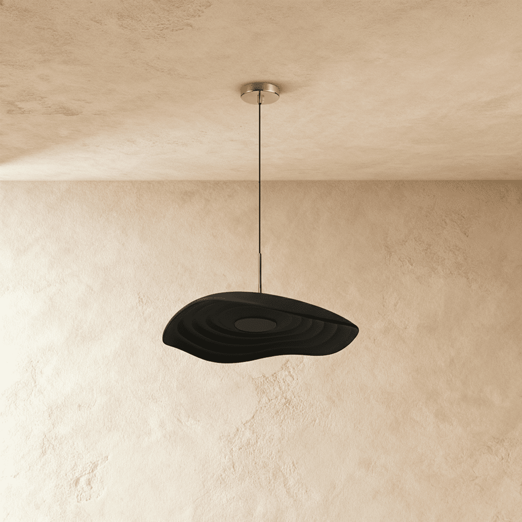 Clérachic wavy black resin pendant with concentric ripples, hanging from a polished canopy against plaster