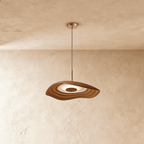 Clérachic rippling resin pendant in terracotta brown with a white glowing interior, hung from a slim cord