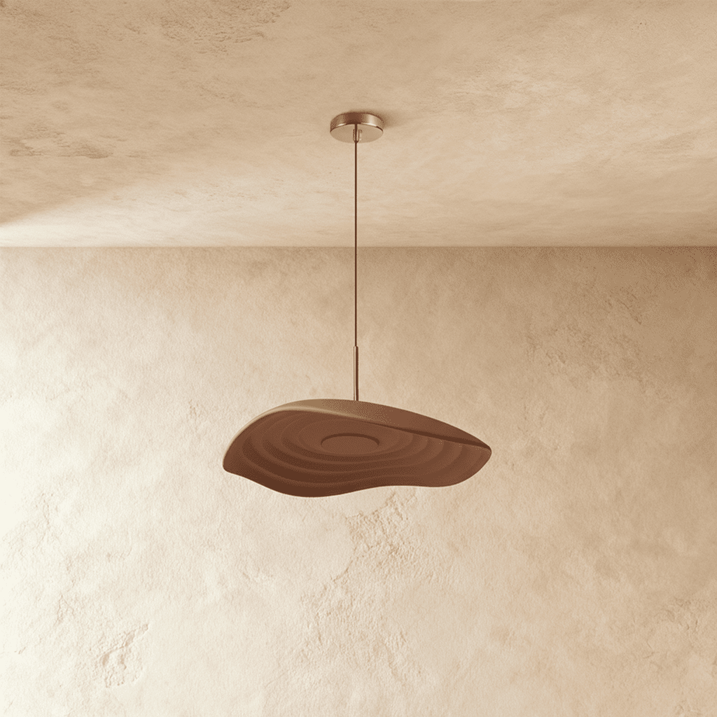 Clérachic wavy resin pendant in a solid chocolate brown, concentric ripples on its underside, plaster backdrop