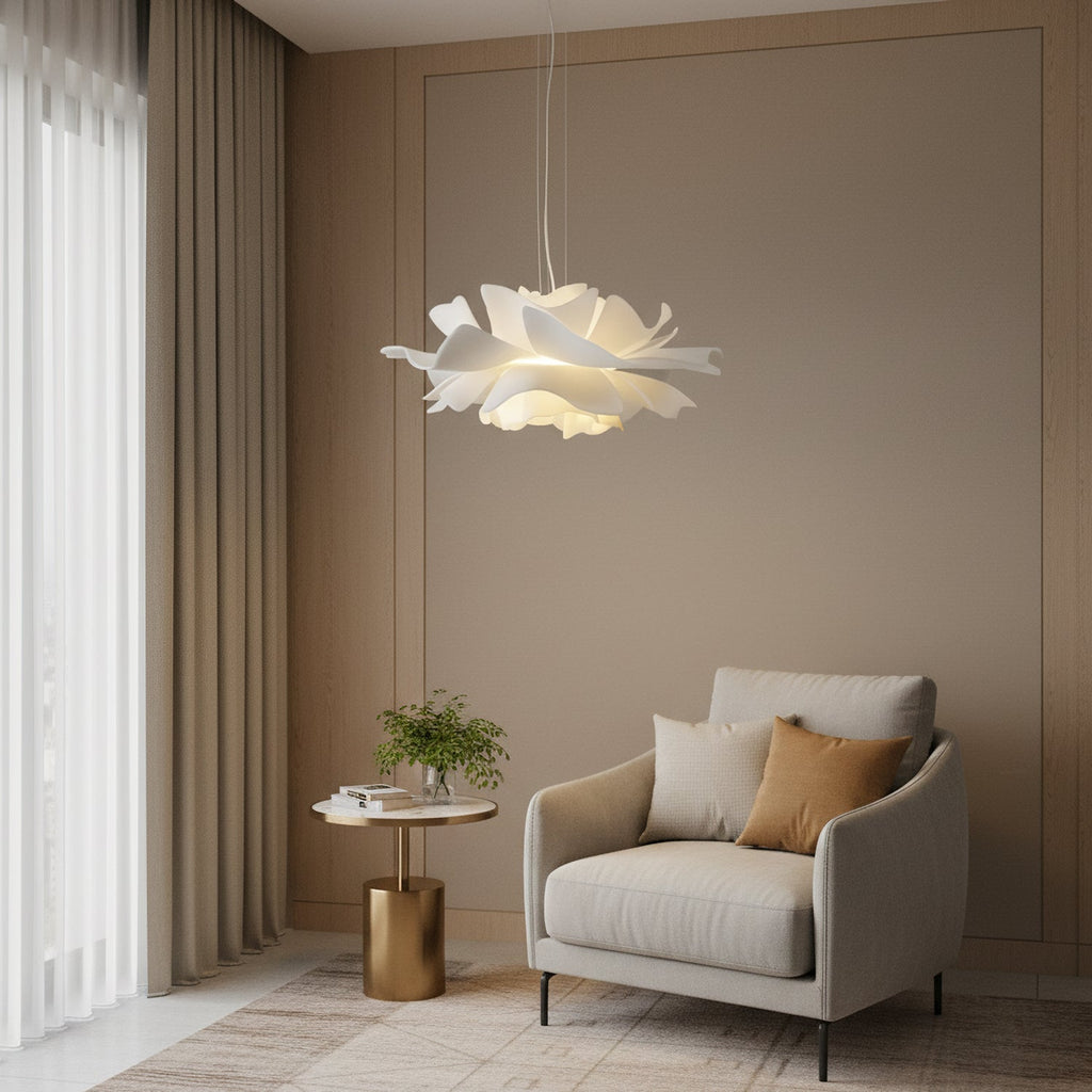 Clérachic white petal pendant in a taupe-walled room, above a pale armchair and a small brass side table.
