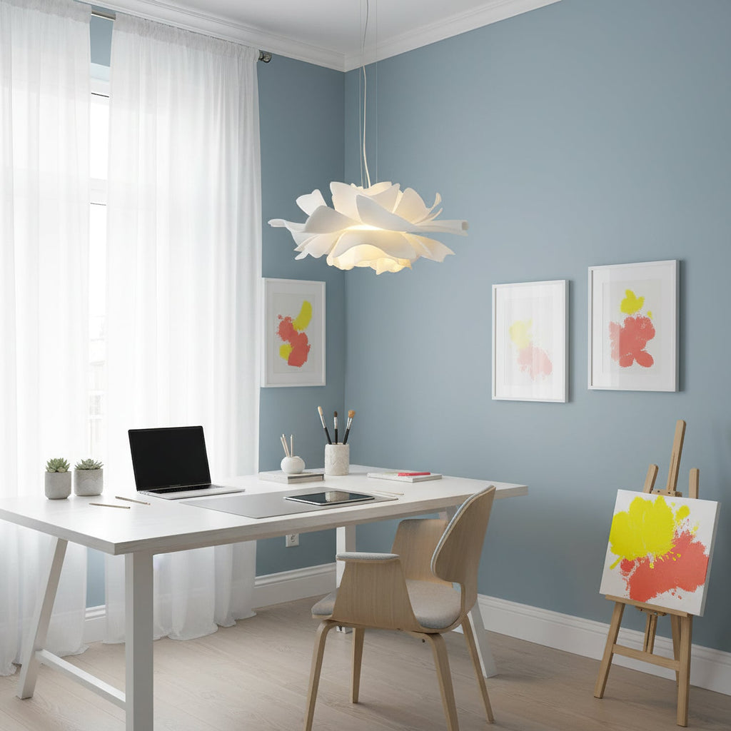 Clérachic white petal pendant in a blue-grey room with a white desk, an easel and bright framed prints.