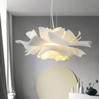 Close view of the layered petals on this lit Clérachic pendant, with a round pale mirror and vases below.