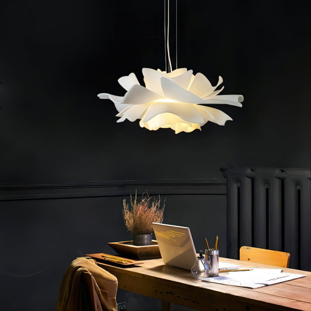 Clérachic white petal pendant above a wooden desk with a laptop and plants, against a charcoal wall.