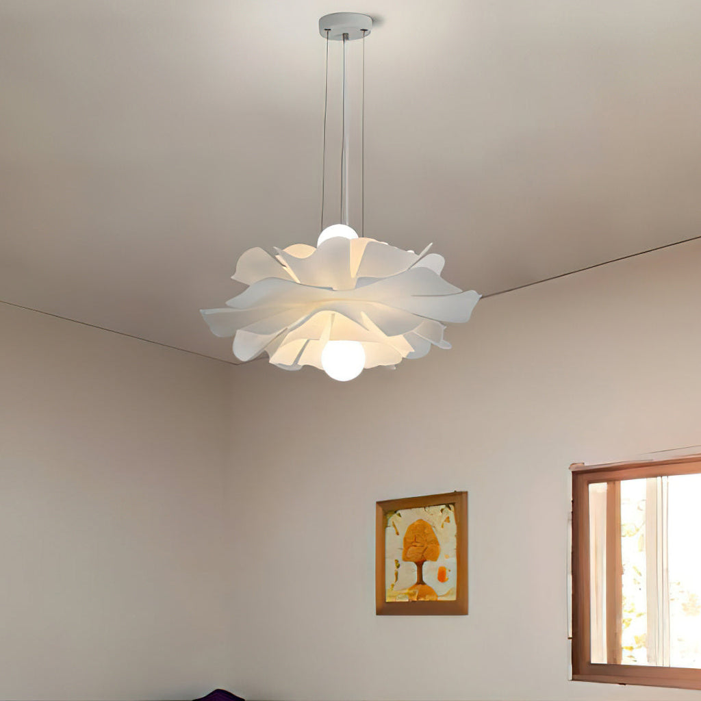 Clérachic white petal pendant on a ceiling canopy in a plain room, with a framed picture and a small window beside it.