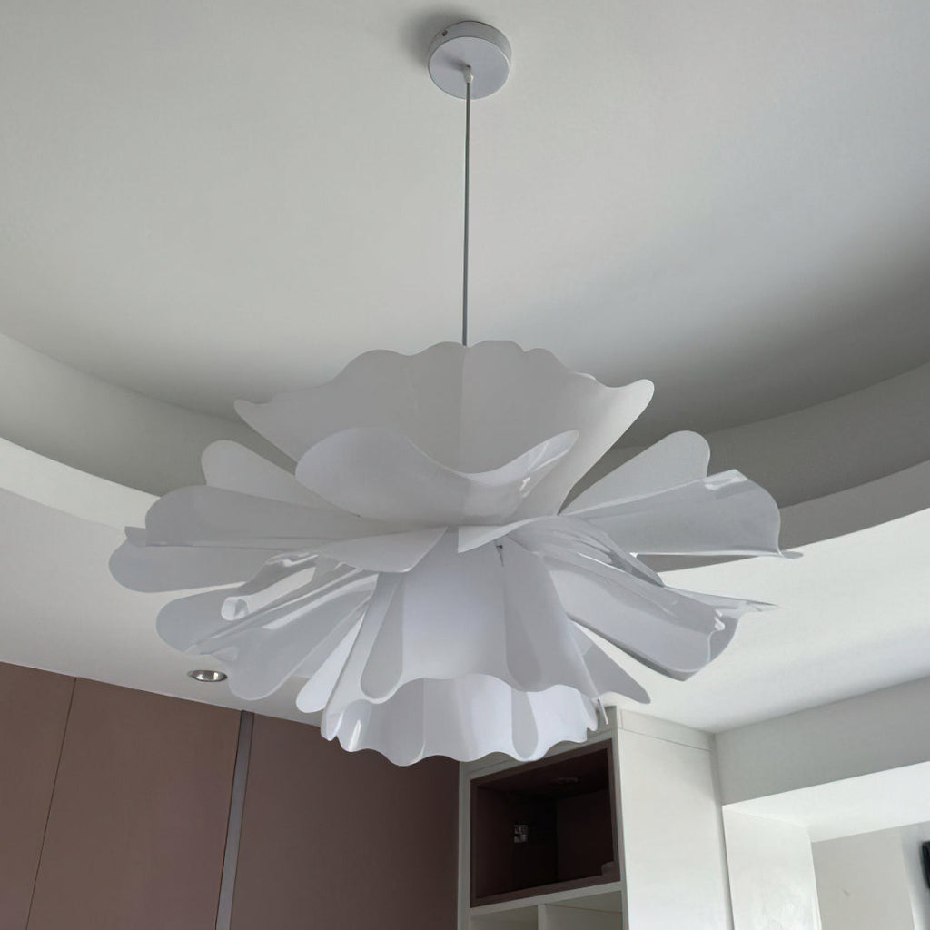 Clérachic white petal pendant with ruffled edges, seen from below on a white canopy above a built-in cabinet.