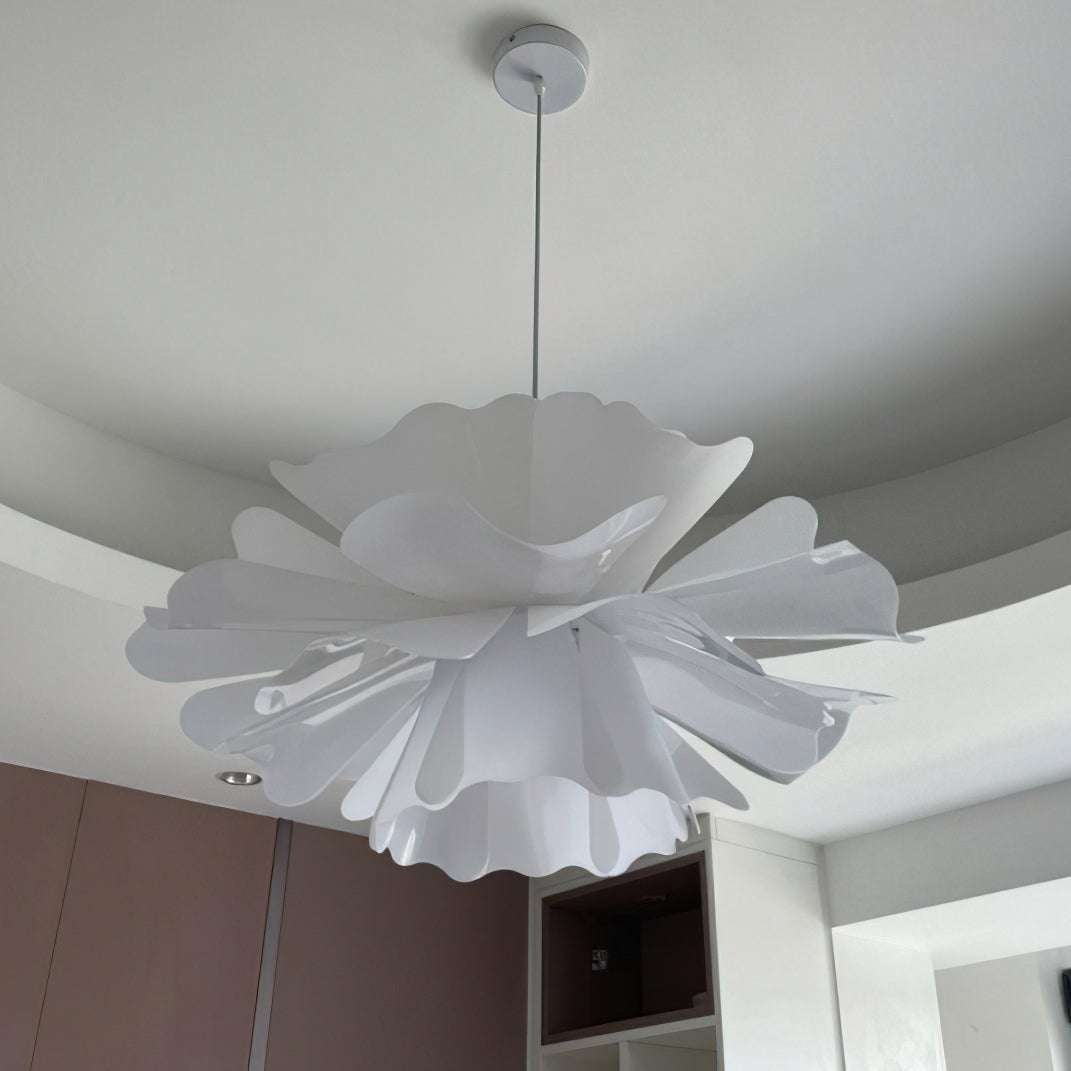 Clérachic white petal pendant with ruffled edges, seen from below on a white canopy above a built-in cabinet.