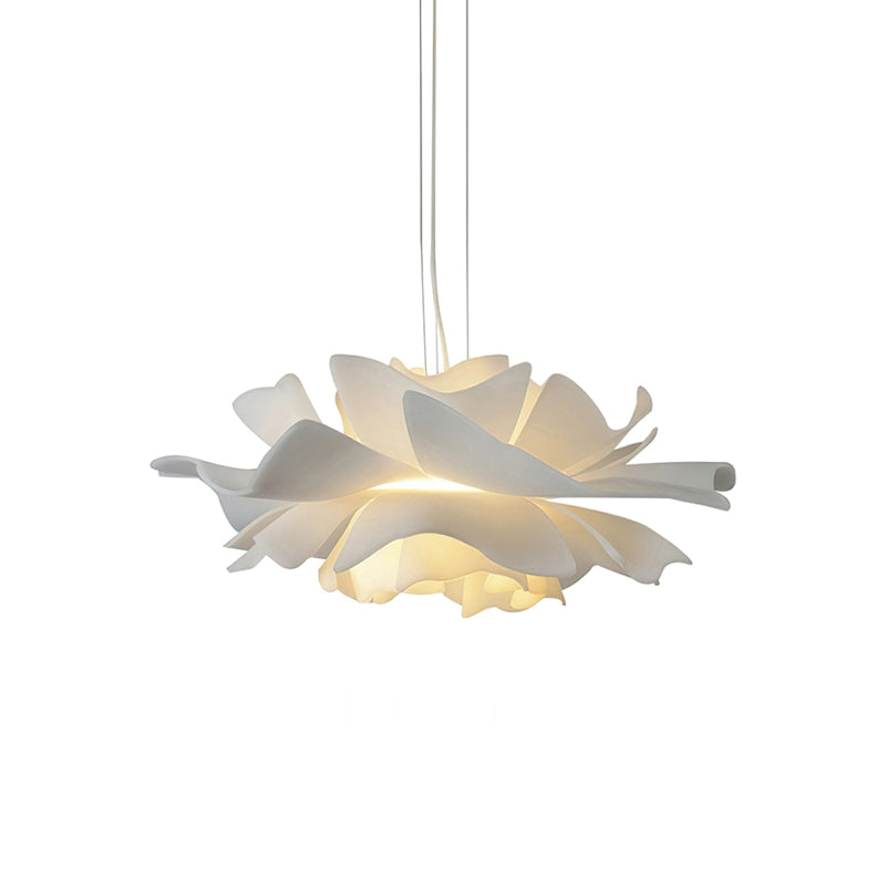 Clérachic white petal pendant with a soft glow under the lowest layer of petals, on a white backdrop.