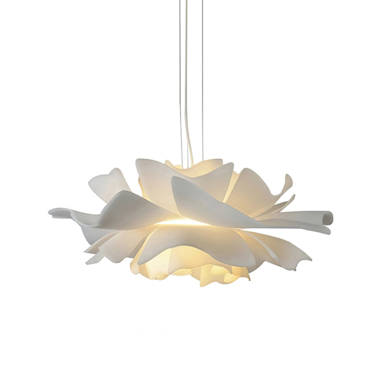 Clérachic white petal pendant with its layers of petals lit from inside, on a white backdrop.