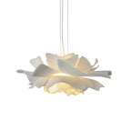 Clérachic white petal pendant with its layers of petals lit from inside, on a white backdrop.