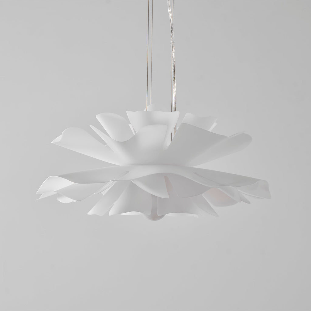 Clérachic white petal pendant with its lowest petals in sharp focus, hung on clear cables against a pale grey backdrop.