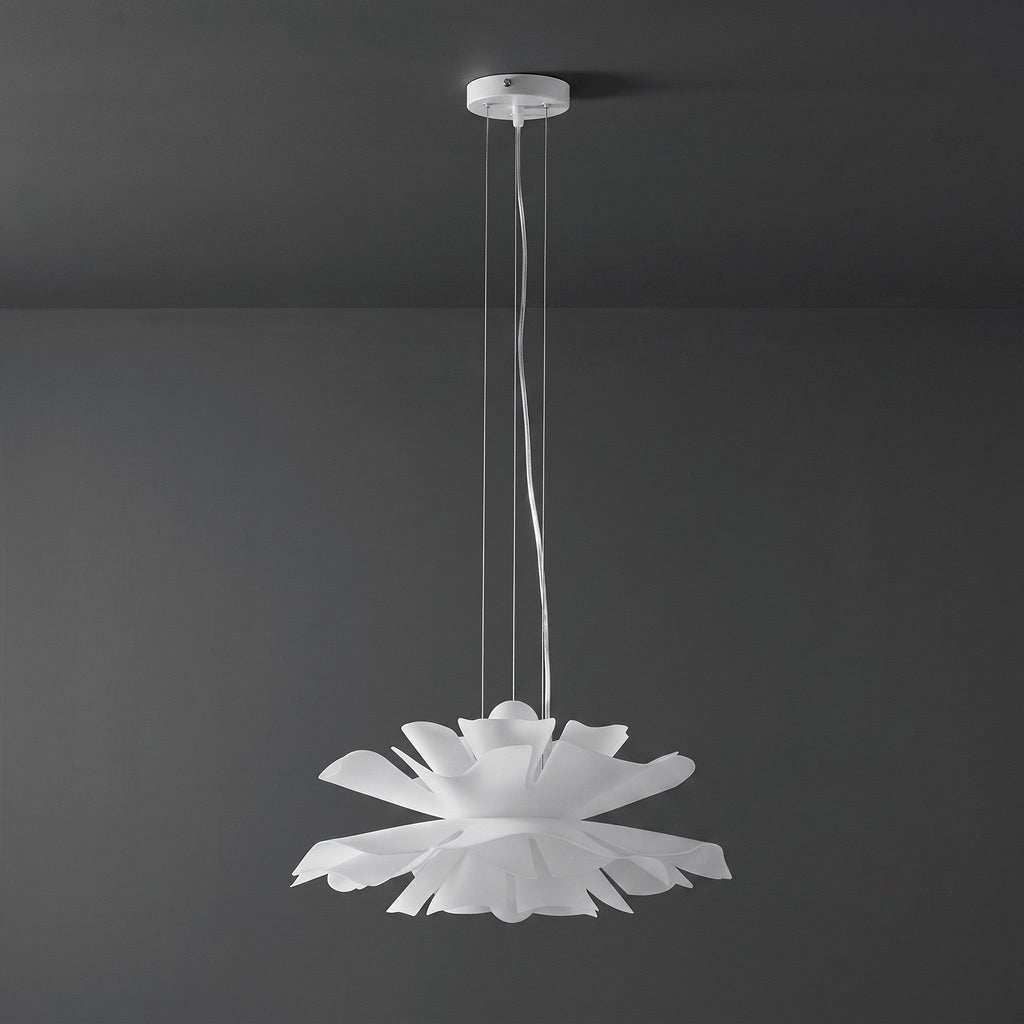 Clérachic white petal pendant with a white ceiling canopy, unlit, against a dark grey wall.