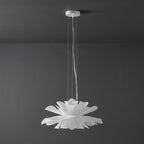 Clérachic white petal pendant with a white ceiling canopy, unlit, against a dark grey wall.