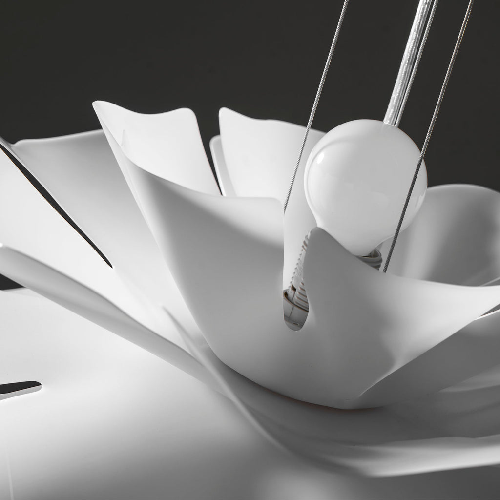Close view of the white petals folding around the round bulb on this Clérachic pendant.