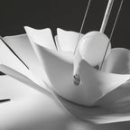 Close view of the white petals folding around the round bulb on this Clérachic pendant.