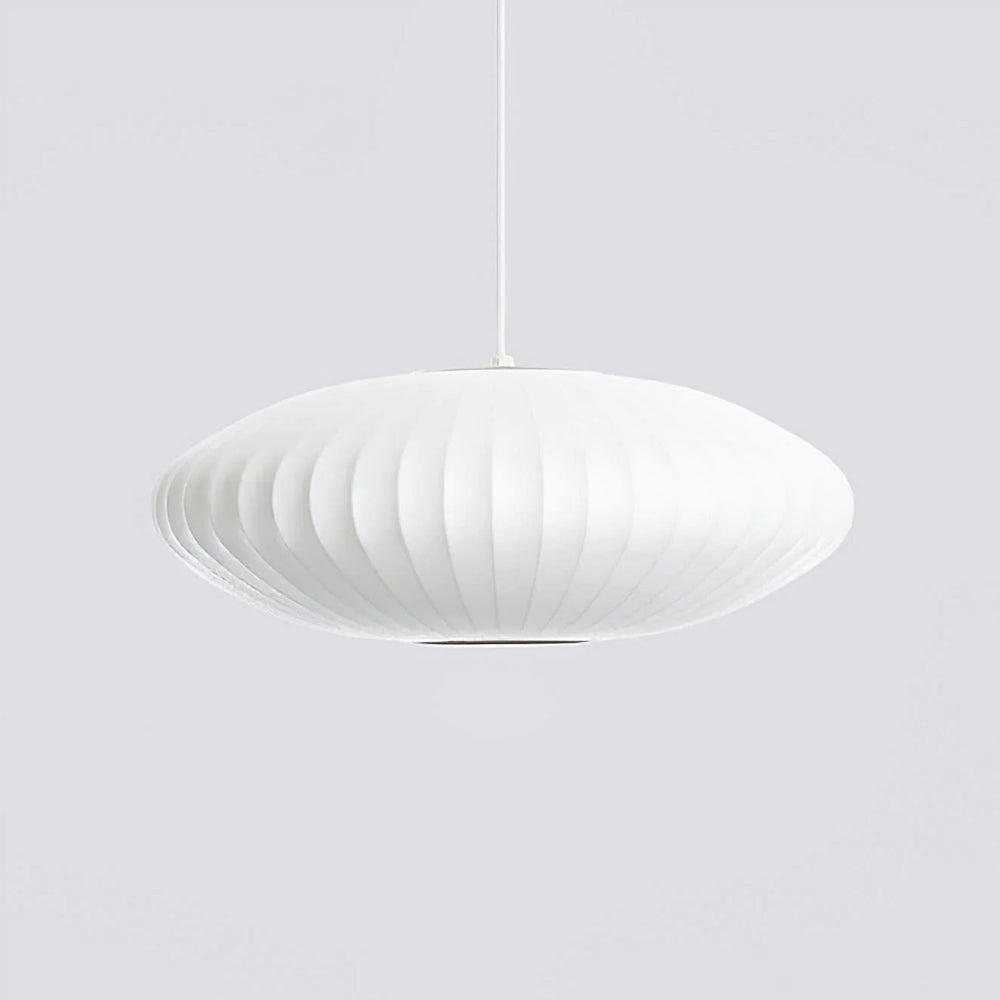 A flat, wide Clérachic pendant in white hangs on grey, with a darker opening visible beneath the ribbed shade.