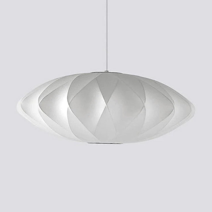 A very wide Clérachic pendant with a diamond-patterned white shade hangs on a grey backdrop, its rim thin and light.