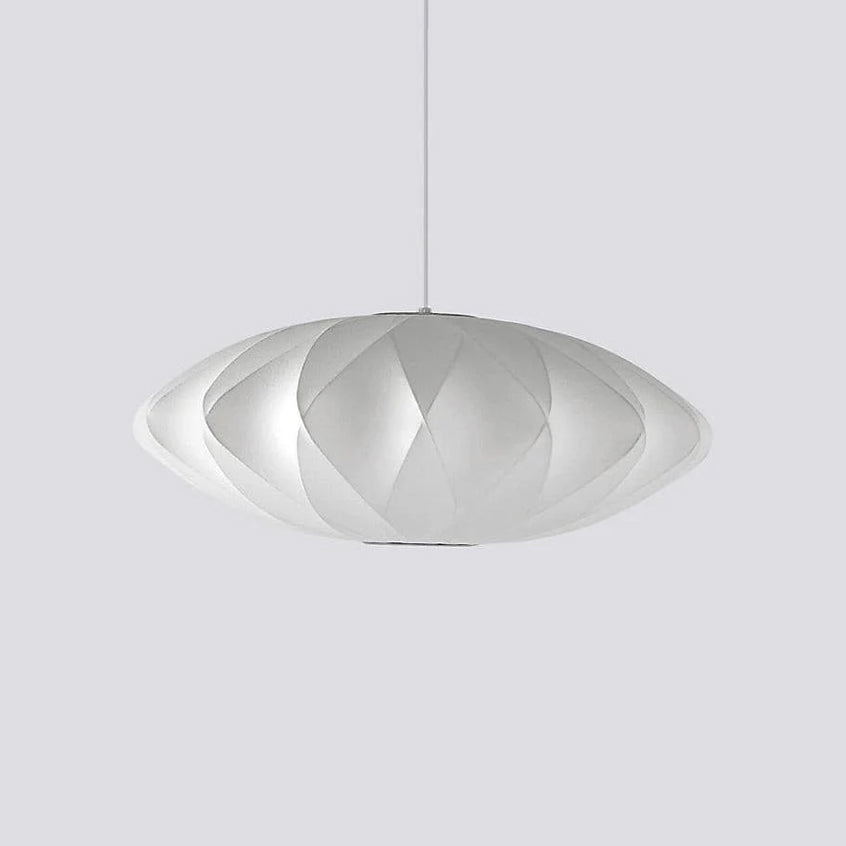 On pale grey, a medium-sized Clérachic pendant with a diamond criss-cross shade hangs from a thin white cord.