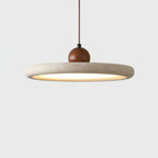 Close side view of the thick pale stone-look rim, walnut-toned wooden bead and warm underlight of this Clérachic pendant, on white.